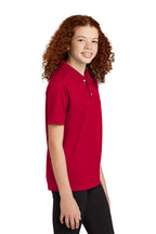 Sport-Tek YST740 youth UV performance school polo in Deep Red – model side view